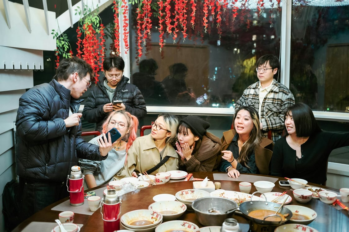 Friends around a table for a meal. Photo by tommao wang on Unsplash.