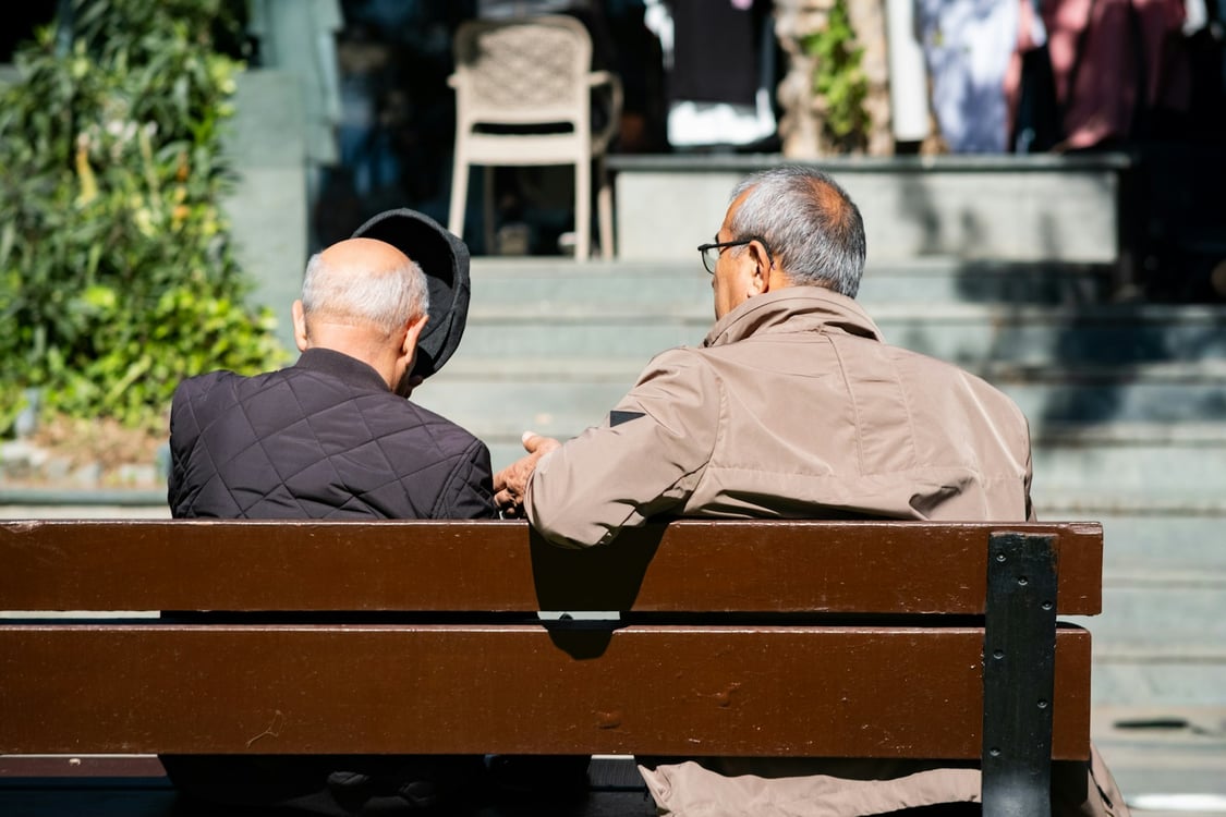Two older men on a park bench. Photo by Aysegul Aytören on Unsplash.
